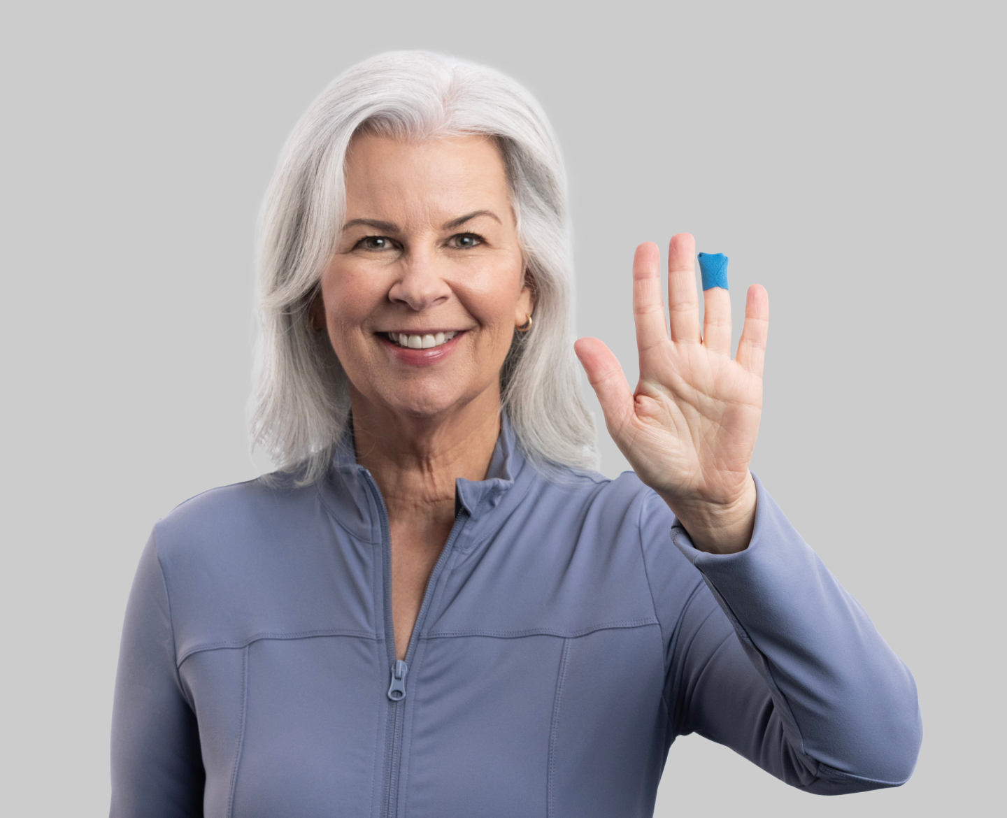 Photo of woman with blue bandage on finger